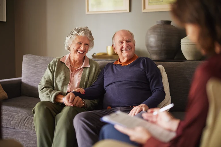 Older couple meeting with a hospice professional at home to discuss hospice care options and eligibility