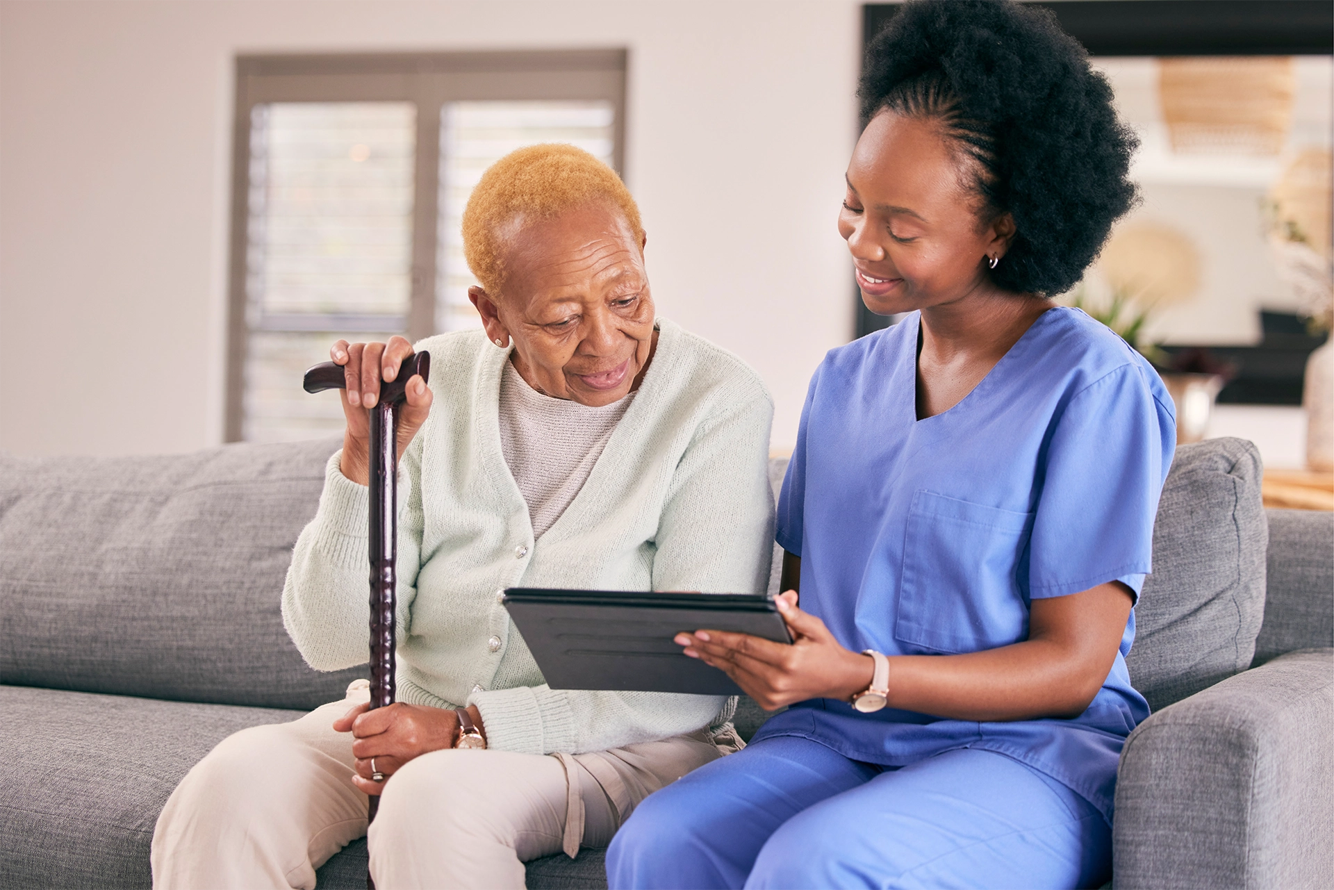 Hospice nurse reviewing care information with a patient at home